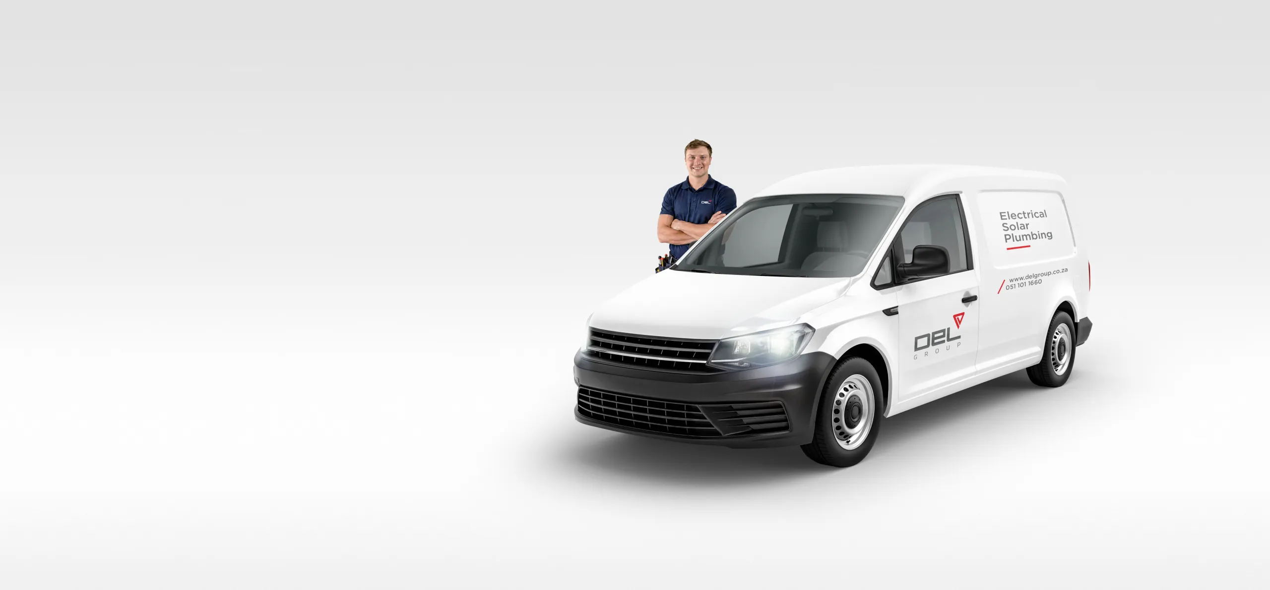 Del Group technician next to a branded Del Group electrical, solar and plumbing service van in Bloemfontein