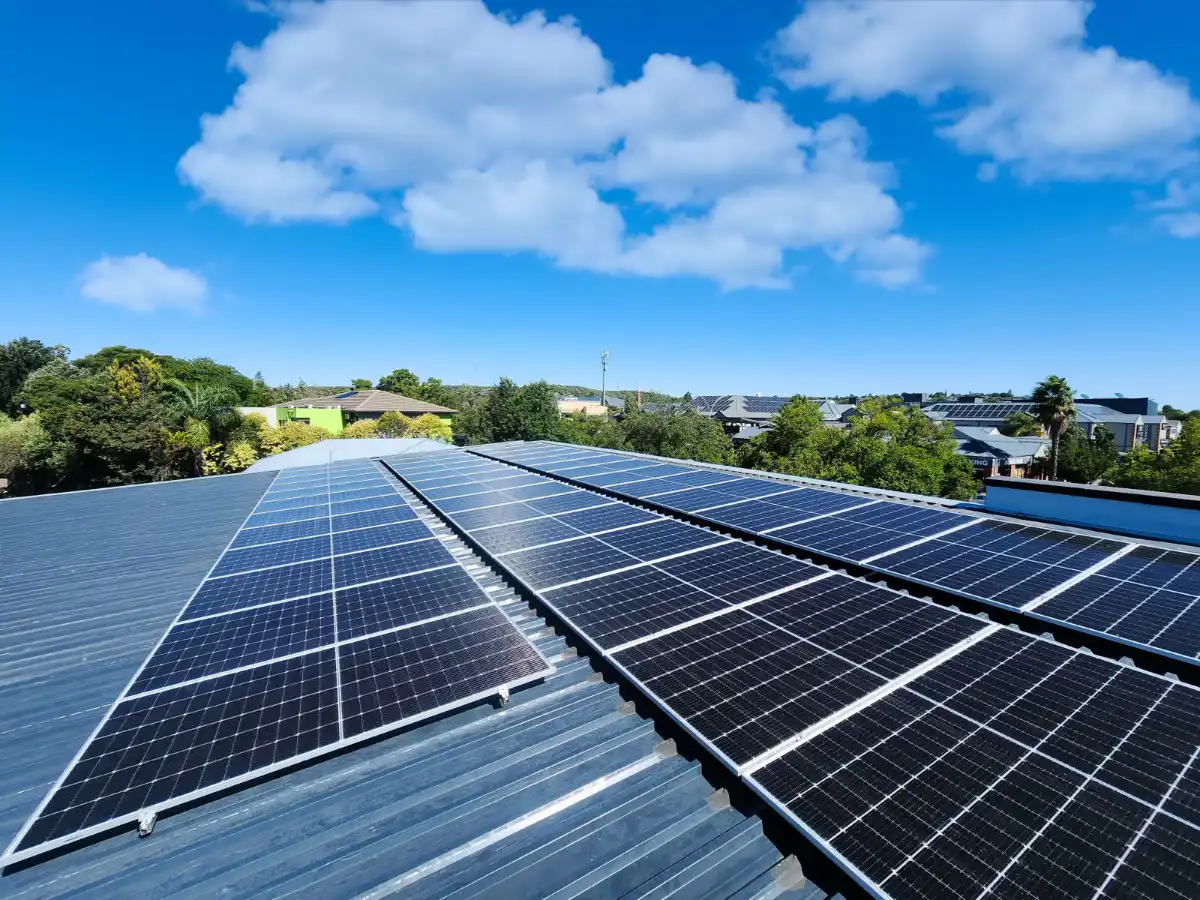 Modern solar panels installed on residential home rooftop in Bloemfontein with blue sky background